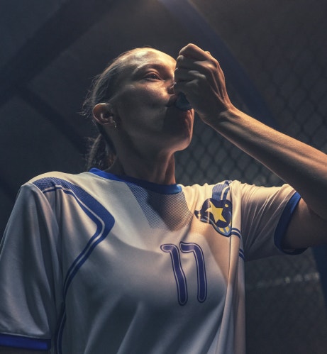 Female footballer using an inhaler